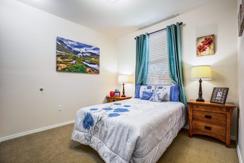 a full bed underneath a window